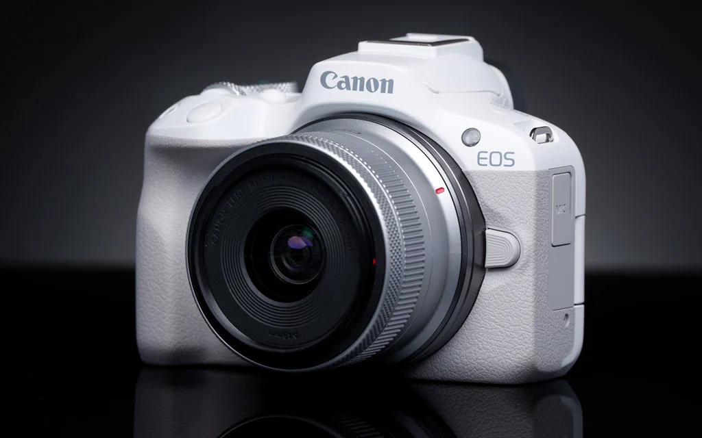 Canon EOS R50 mirrorless camera on a dark product-photography background.