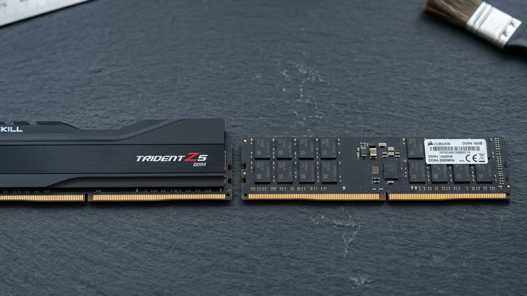 DDR5 and DDR4 desktop memory modules side by side on a slate workbench.