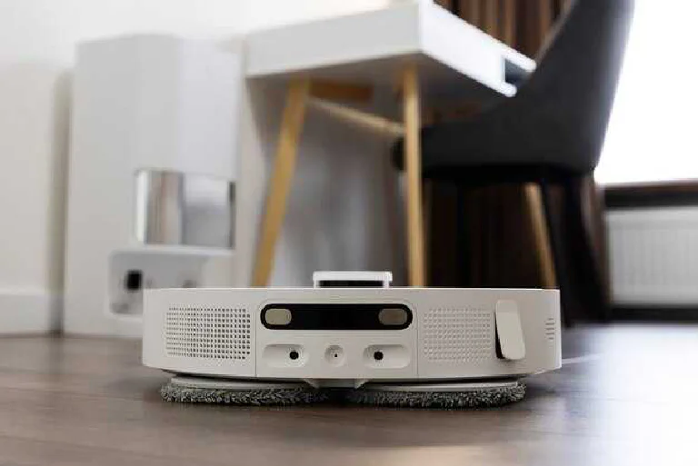 A sleek robot vacuum, a lightweight cordless stick vacuum, and a powerful traditional vacuum displayed side-by-side.