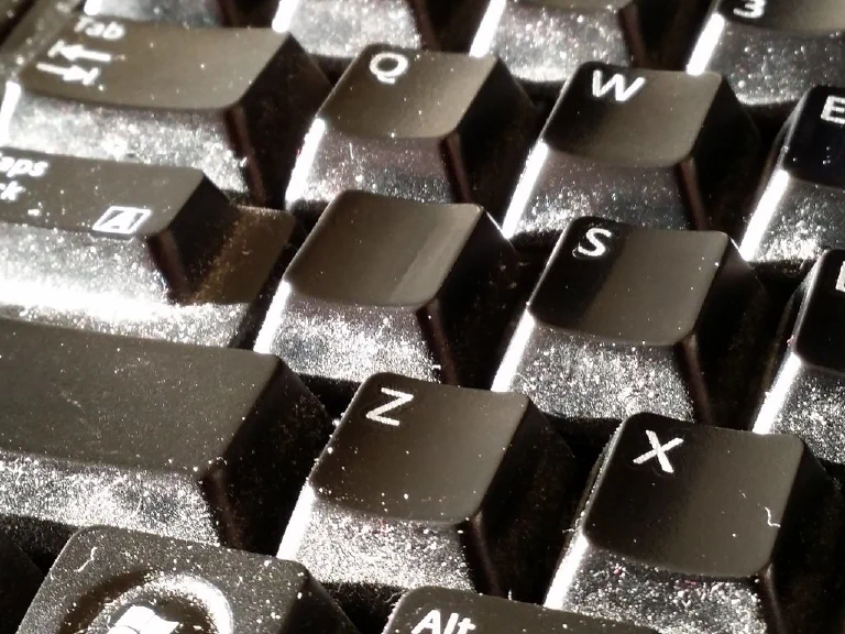 A gaming keyboard with a large bank of unused, dusty macro keys on the side.