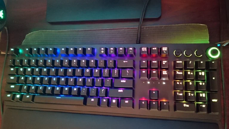 A sleek, customized Keychron Q5 HE and a Razer Huntsman V2 Analog side-by-side on a premium desk mat.