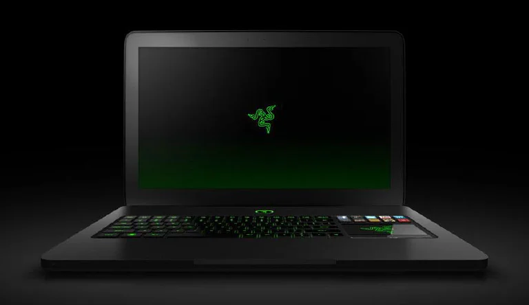 A collection of genuine Razer products, including a gaming laptop, mouse, and headset, neatly arranged.