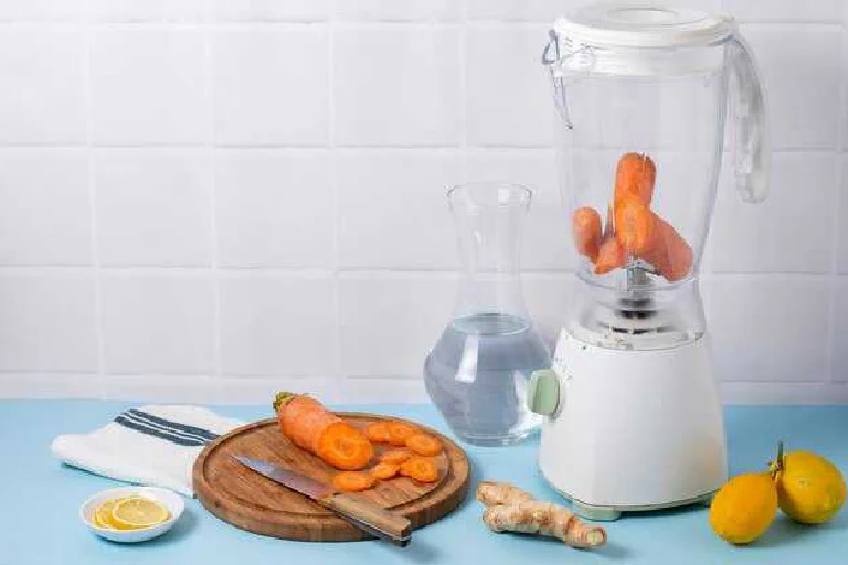 A high-quality electric meat grinder on a kitchen counter with freshly ground meat.