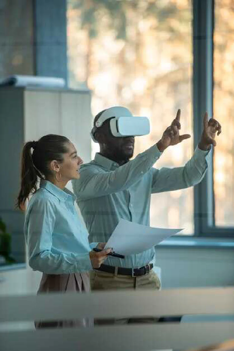 A person wearing a sleek VR headset, interacting with floating holographic data in a modern office.