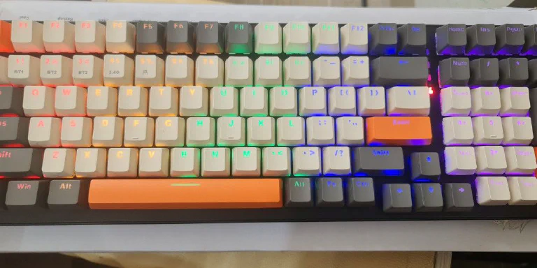 The Ziyoulang K6 keyboard on a desk, showcasing its compact 65% layout and backlighting.